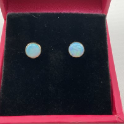 A pair of 9ct gold studs set Opal. Postage category A.