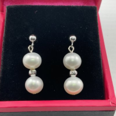 A pair of 9ct white gold and pearl drop earrings. Postage category A.