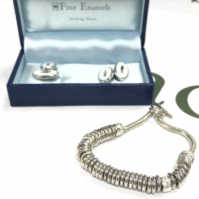A white metal Links of London bracelet and a boxed pair of enamel and silver cufflinks. Postage cat A