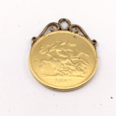 A 1887 &pound;5 gold coin with mount. 41.17g Postage A