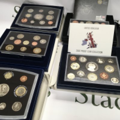 Collection of 5 United Kingdom proof coin sets including 2000 2001 2004 2007 and 2008 Postage B