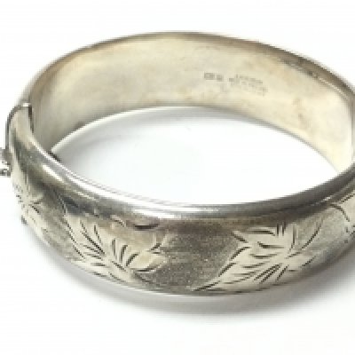 A silver hallmarked bangle , postage category A