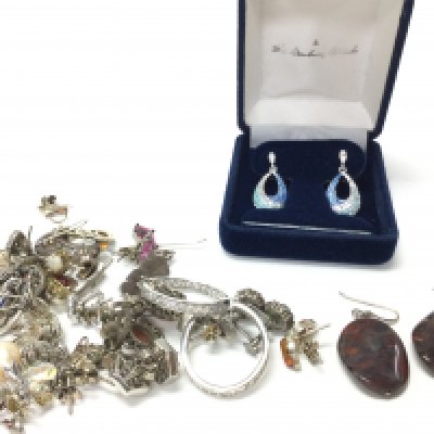 A collection of silver earrings. Postage category A