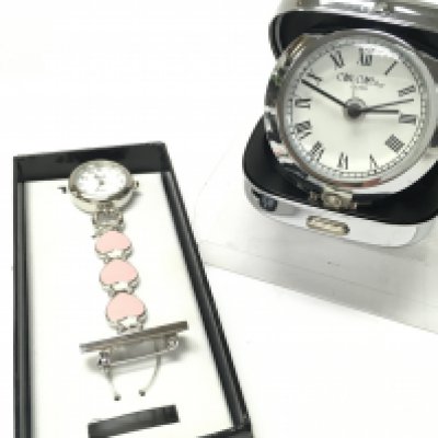 Two time pieces, a heart design brooch pendant watch by Ravel and a pop up travel clock by W Widdop
