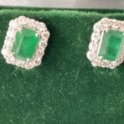 Pair of 18ct white gold rectangular earrings with chamfered corners, set with step cut emeralds and RBC diamonds, boxed. Emeralds 1.30ct. Diamonds 0.68ct approx. Postage category A.