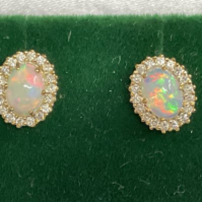 Pair of 9ct yellow gold oval cabochon Opal and RBC diamond cluster studs, boxed. Opals 1.08ct. Diamonds 0.29ct. Postage category A.