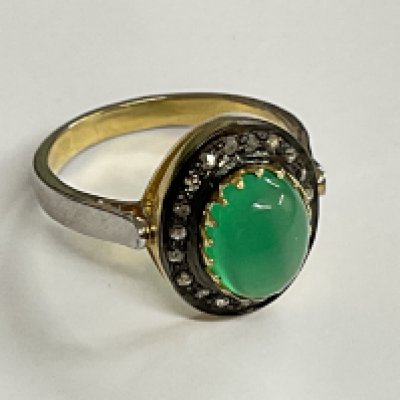 Cabochon green onyx and diamond halo ring, set in silver. Onyx 1.91ct. Diamonds 0.22ct. Ring size approx N. Postage category A.