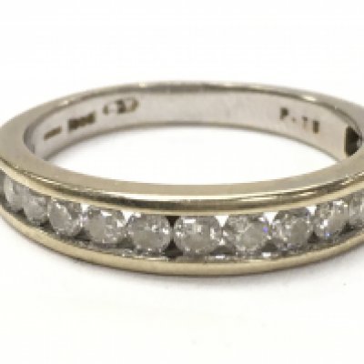 An 18ct half eternity ring, size O, total weight 3.7g. 0.75ct total diamond and Moissanite. Postage category A