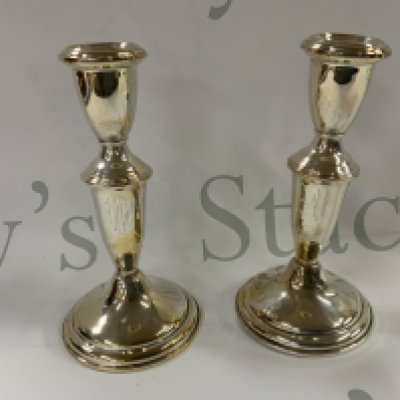 A pair of Sterling silver candlesticks. 15cm (A)