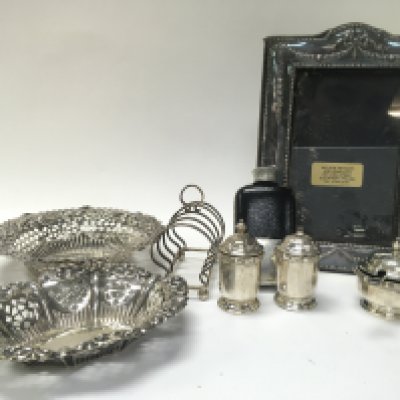 A Collection of silver hallmarked items including bonbon dishes, a photo frame, Scottish silver S/P shakers, rack, non silver flask. This lot cannot be posted