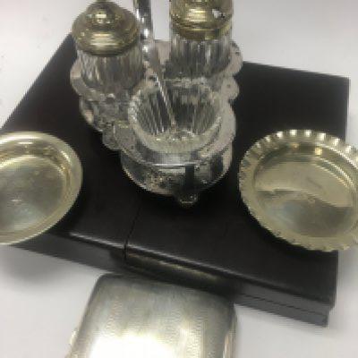 A bag containing silver plated ware various including cutlery a pair of small dishes and a cigarette case