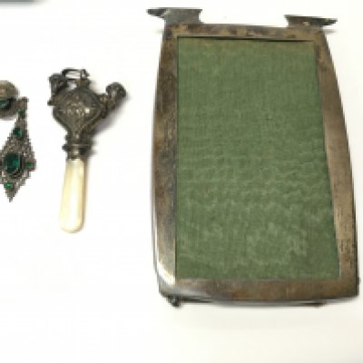 A silver picture frame and childs rattle and a pair of vintage dress earrings. Postage B