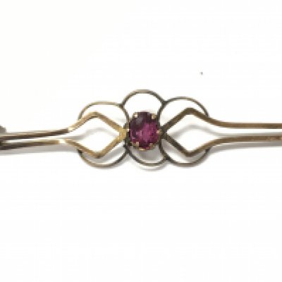 A 9ct gold brooch set with a small ruby. 1.60g