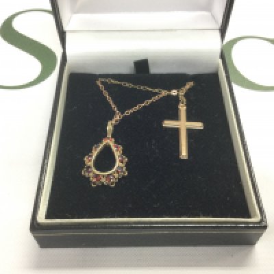 Two 9ct gold pendants on chains comprising a cross and one set with garnets. Shipping category A.