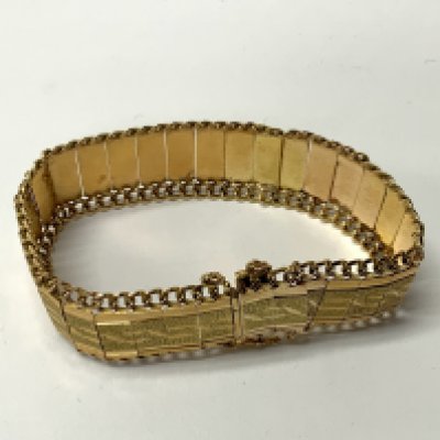 Circa1970s high carat gold bracelet, tested minimum 21ct, joined bar and chain design with etched panels. (A) total weight 34.68g.