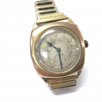 A 9ct gold watch on an expandable strap. seen running.