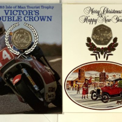 3 Pobjoy Mint Isle of Man Christmas cards inset with 50p coins, 1980, 1983, 1984 together with a 1983 Victory TT double crown 50p