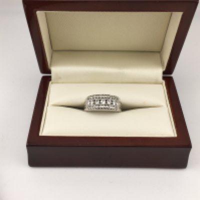A white metal ring( tested 18ct not hallmarked) set with diamonds. Approx weight 9.63 grams, size O.