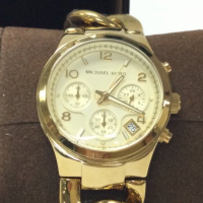 A Michael Kors yellow watch on curb link bracelet. With paperwork and seen running. Postage B