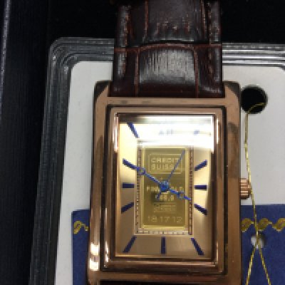 A gents wrist watch containing 1g credit suisse gold ingot. Postage B
