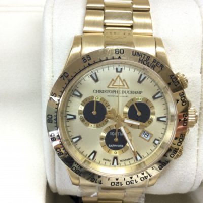 A gents Christophe Duchamp gold tone automatic wrist watch. In unworn condition and seen running. Postage B