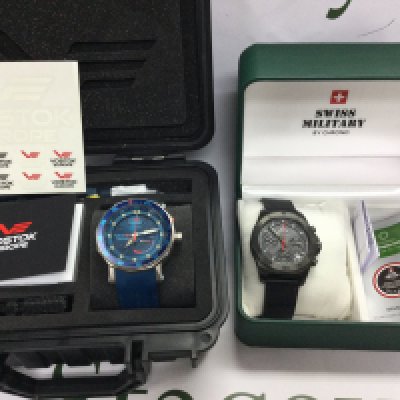 A Vostok Europe watch with box and papers and one other. Postage B