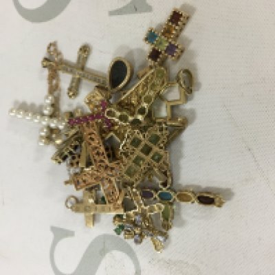 A large collection of gold cross pendants. Approx weight 33.9 grams.