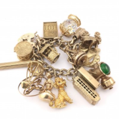 A large 9ct gold charm bracelet set with assorted charms 154.50gPostage B
