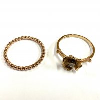 A 9ct gold band, Size P together with a 9ct gold flower ring, Size Q inset with a small chip diamond