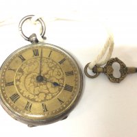 A silver cased key wind pocket watch with an elaborate dial. Seen working
