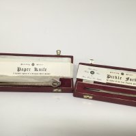 A silver paper knife and silver Pickle folk (2)