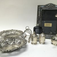 A Collection of silver hallmarked items including bonbon dishes, a photo frame, Scottish silver S/P shakers, rack, non silver flask. This lot cannot be posted