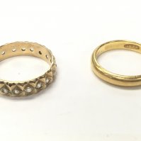 A 22ct gold band and a 9ct band (eternity). Total weight 5.6g. Size J and L. Postage category A