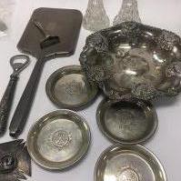 A Collection of silver including four dishes , perfume bottles ( no stoppers ) hand mirror bottle opener medallion and penknife.