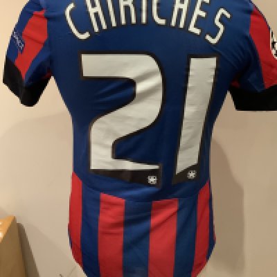 Steaua Bucharest 2013 - 2014 Match Worn Football Shirt: Blue and red short sleeve shirt with Champions League badging to sleeves. Chiriches 21 to rear. Worn during the qualifying campaign. Signed by the player with a dedication. 