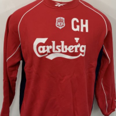 Liverpool 2001 - 2002 Training Top: Red long sleeve Reebok shirt with initials GH to front. Worn by the manager Gerard Houllier. Comes with signed COA from him. 