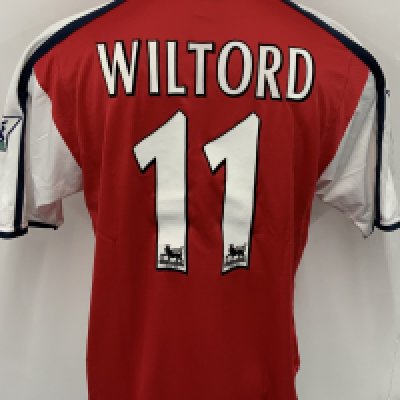 Arsenal 2000 - 2001 Home Match Worn Football Shirt: Red and white short sleeve  Nike Dreamcast shirt with Premier League badging to sleeves. Wiltord 11 to rear. Worn v Manchester City on 28 October 2000. Comes with signed COA from the player who scored in the match.