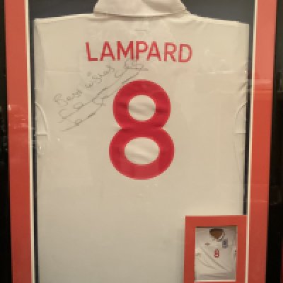 2008 Frank Lampard Match Worn England Framed Football Shirt: White home  shirt with number 8 Lampard to rear. Signed best wishes Frank Lampard next to number 8. Expensively framed in deep frame. Plaque states official 2009 training shirt Holland but it is a match shirt with match details to front which are pictured in frame. Not for posting.