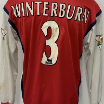 Arsenal 98/99 Home Match Worn Football Shirt: Red long sleeve Nike JVC XL excellent unwashed shirt worn by Winterburn. Gold Premier League Lion on sleeve badging stating Champions 1997 - 1998. Mud staining. 