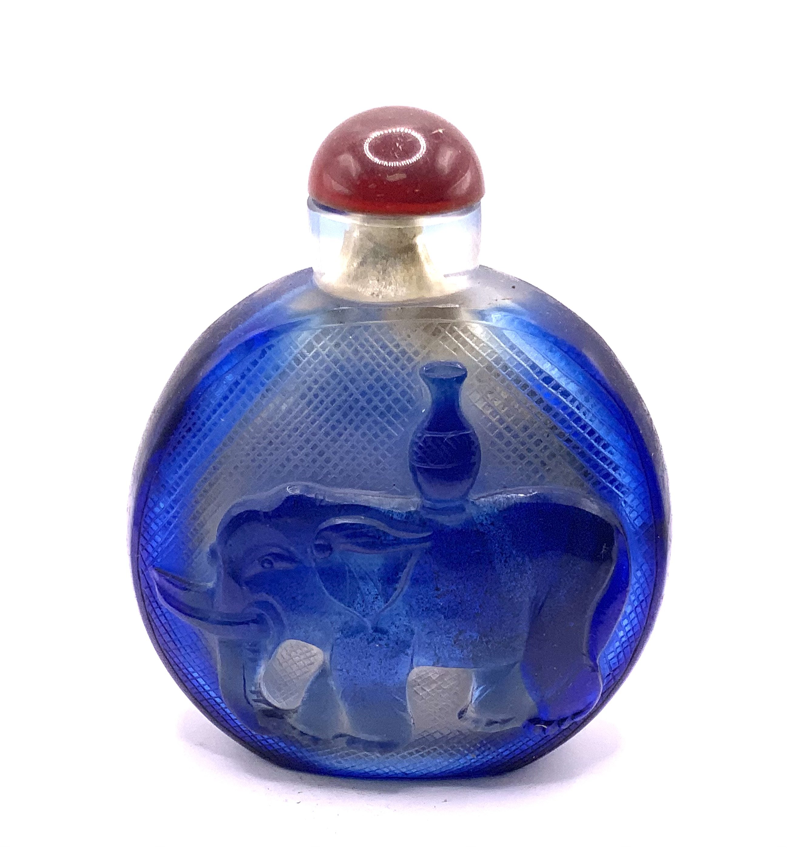 A large Chinese cameo glass snuff bottle with elephant scenes to either side. H.12cm including stopper.