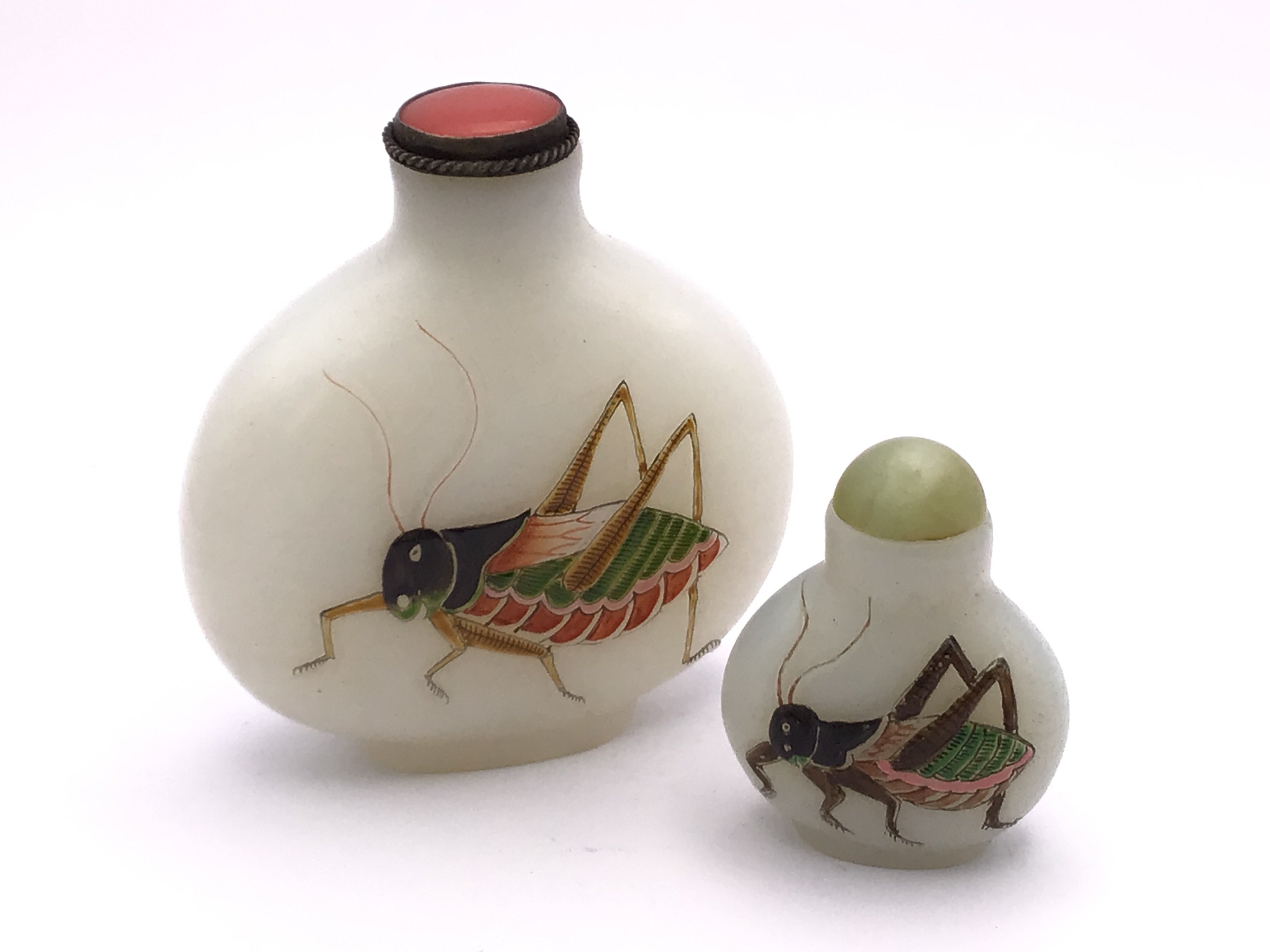 2 Milk glass snuff bottles both with hand painted enamelled crickets. 6.6cm/3.4cm