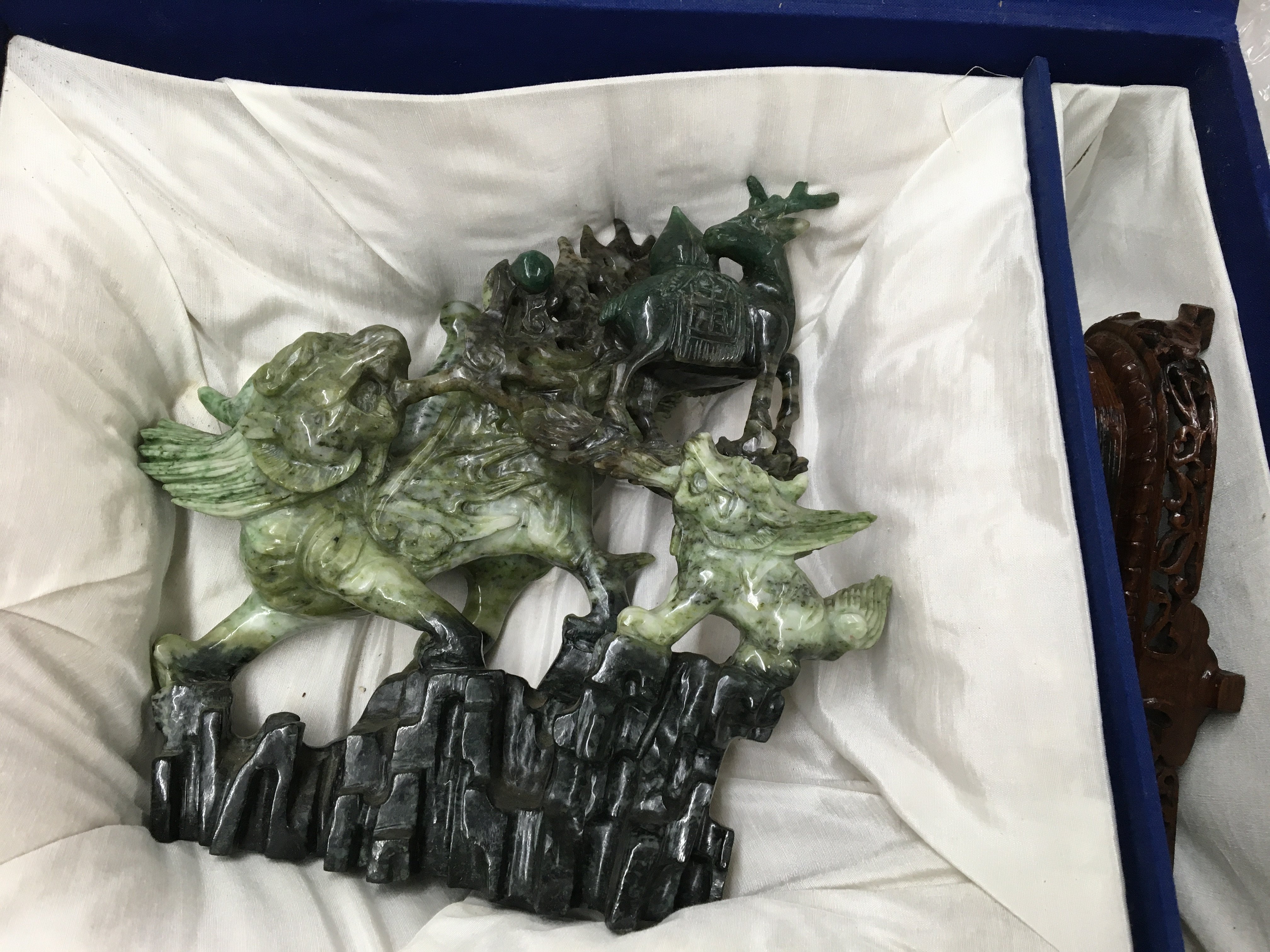 A boxed and carved oriental soap figure of a Dog of foo with wooden base