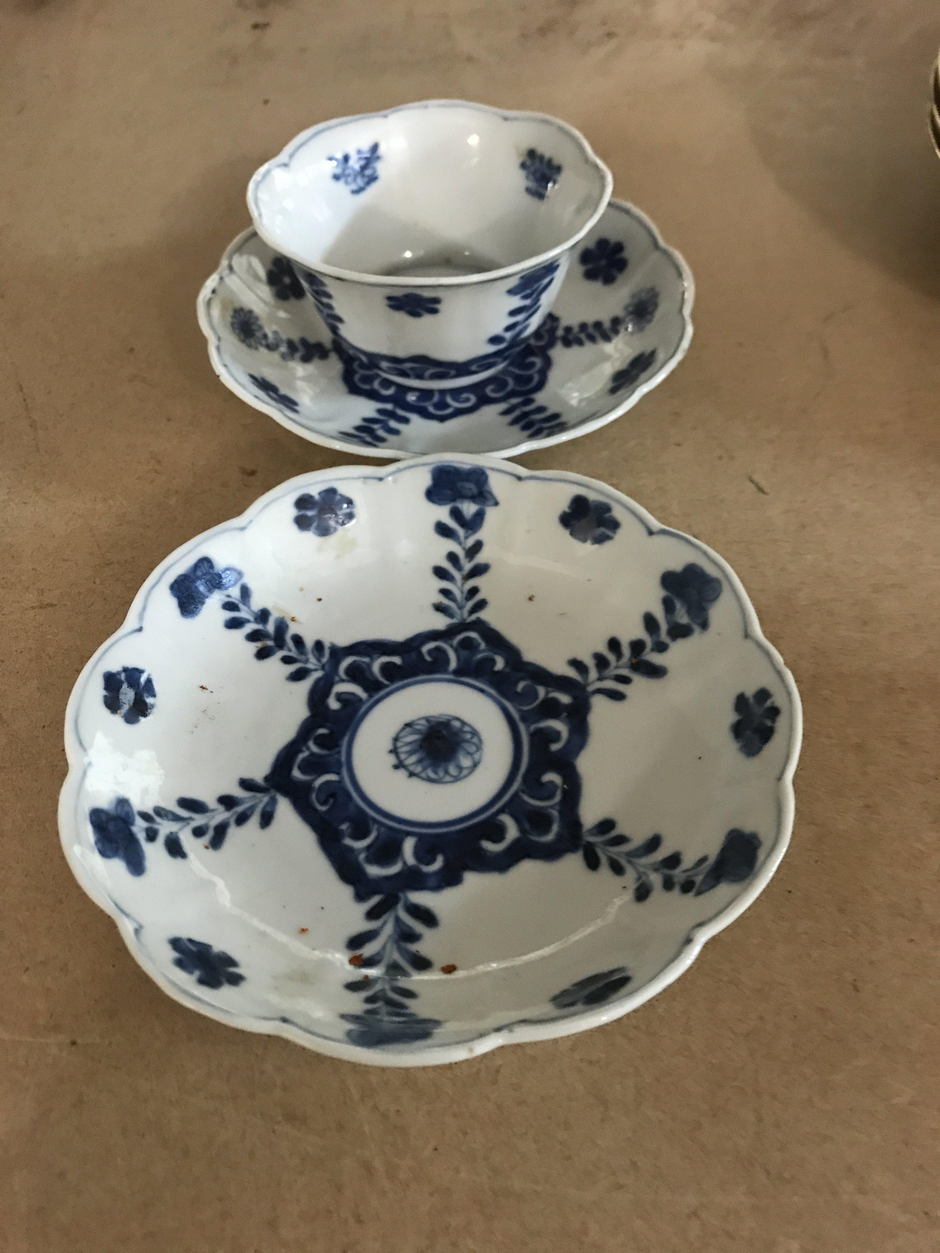 A Chinese tea bowl and saucer plus one other saucer .