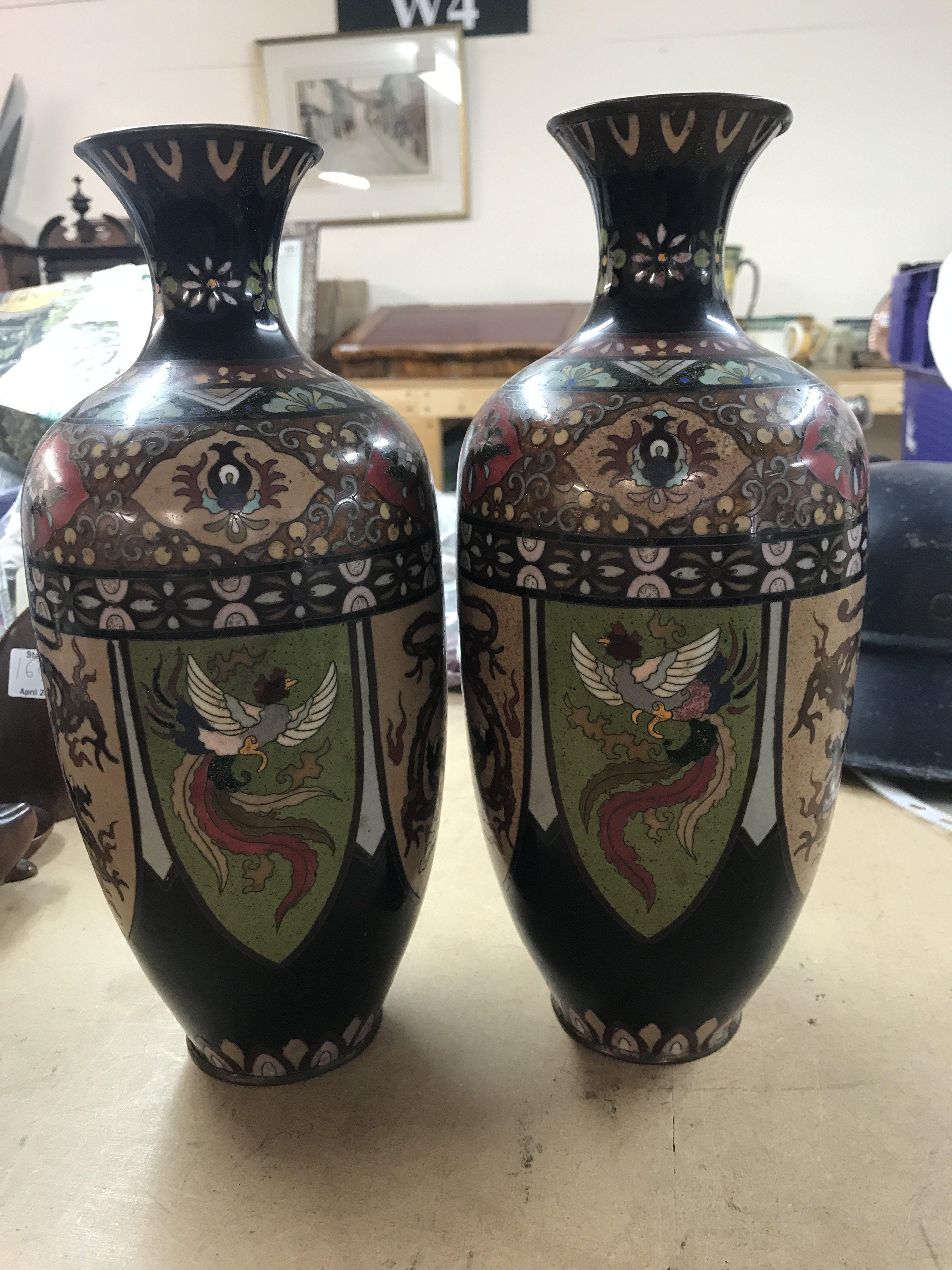 A pair of cloisonn&eacute; vases decorated with birds flowers and foilage 30 cm .