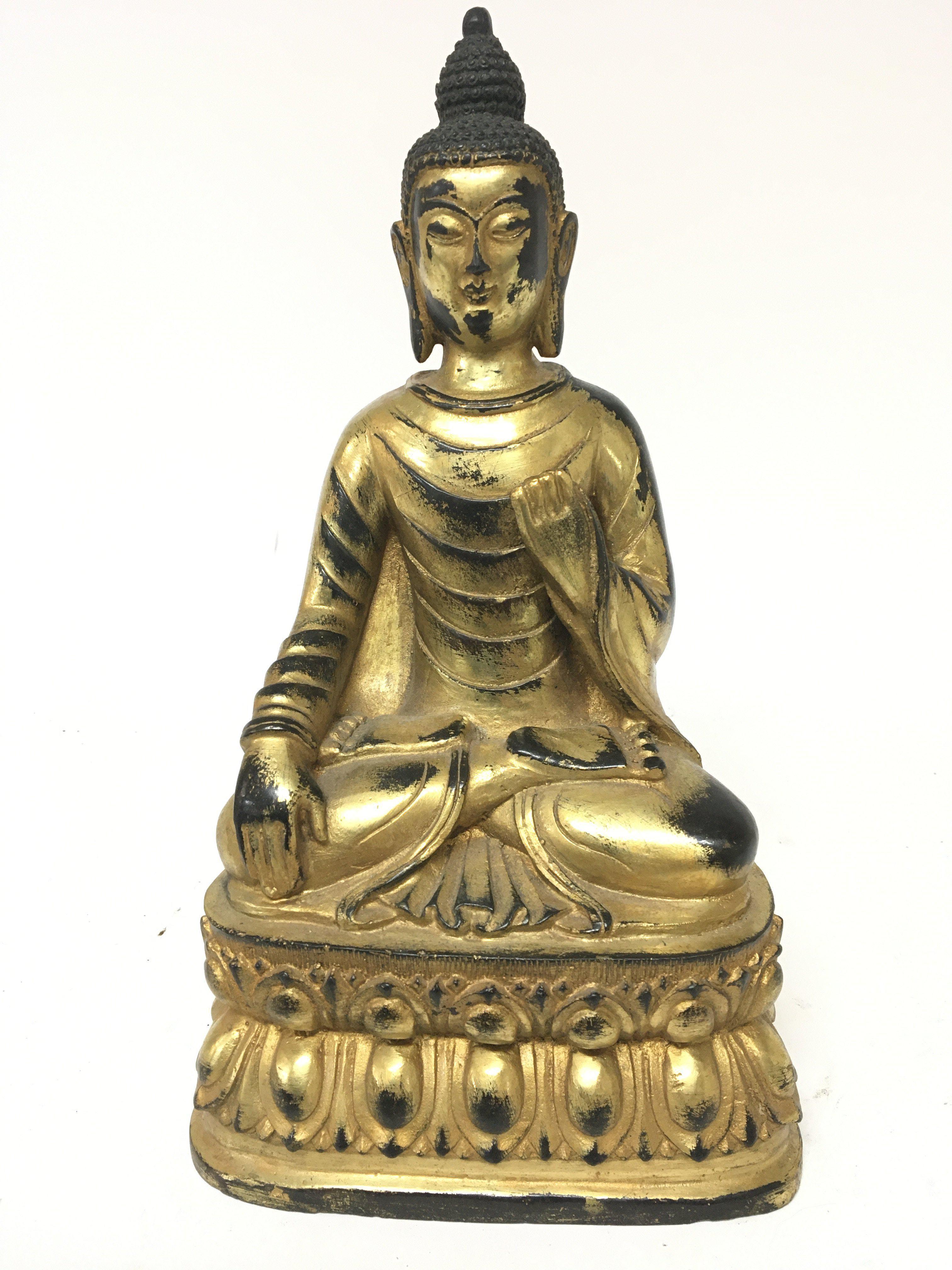 A gilt metal figure of a seated Buddha cast and with an infield base the lower section with a repeat pattern,p. No obvious damage except gilt rubbed height 28cm