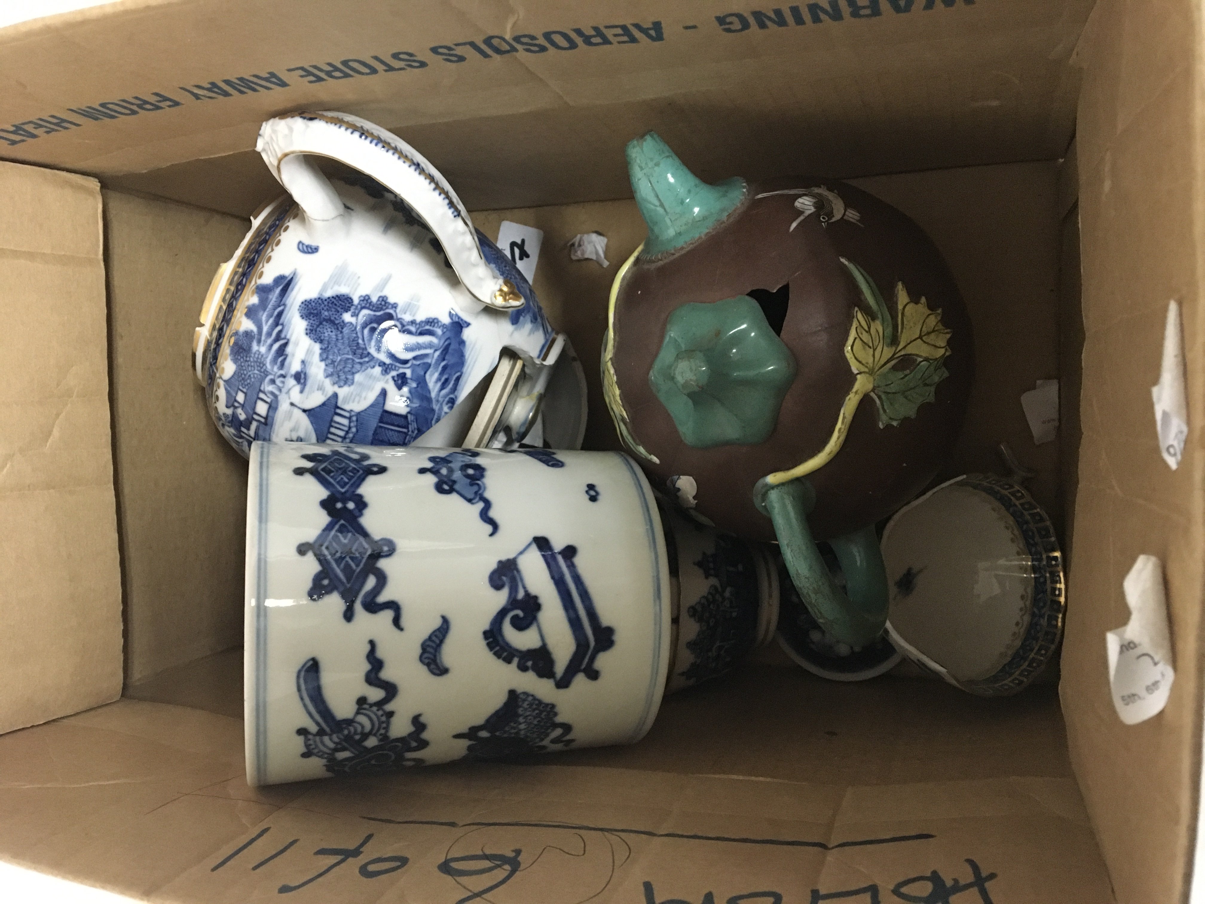 A box containing Chinese 19th century Export porcelain blue and white tea set a blue and white brush pot and a decorated terracotta tea pot extensive damage to most items in this lot (a lot)