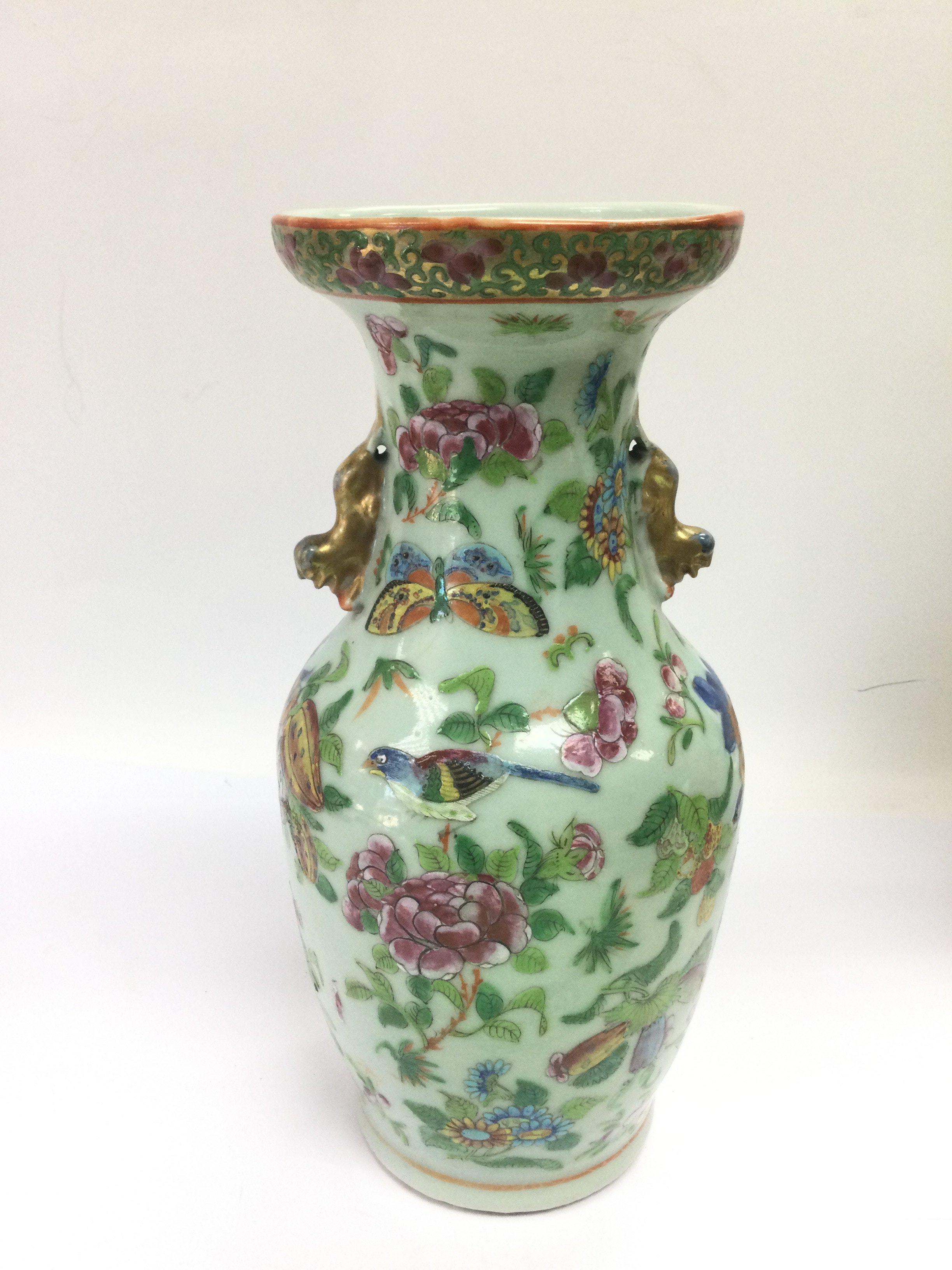 A Canton vase decorated with birds, butterflies and flowers, approx height 24cm. Shipping category D.