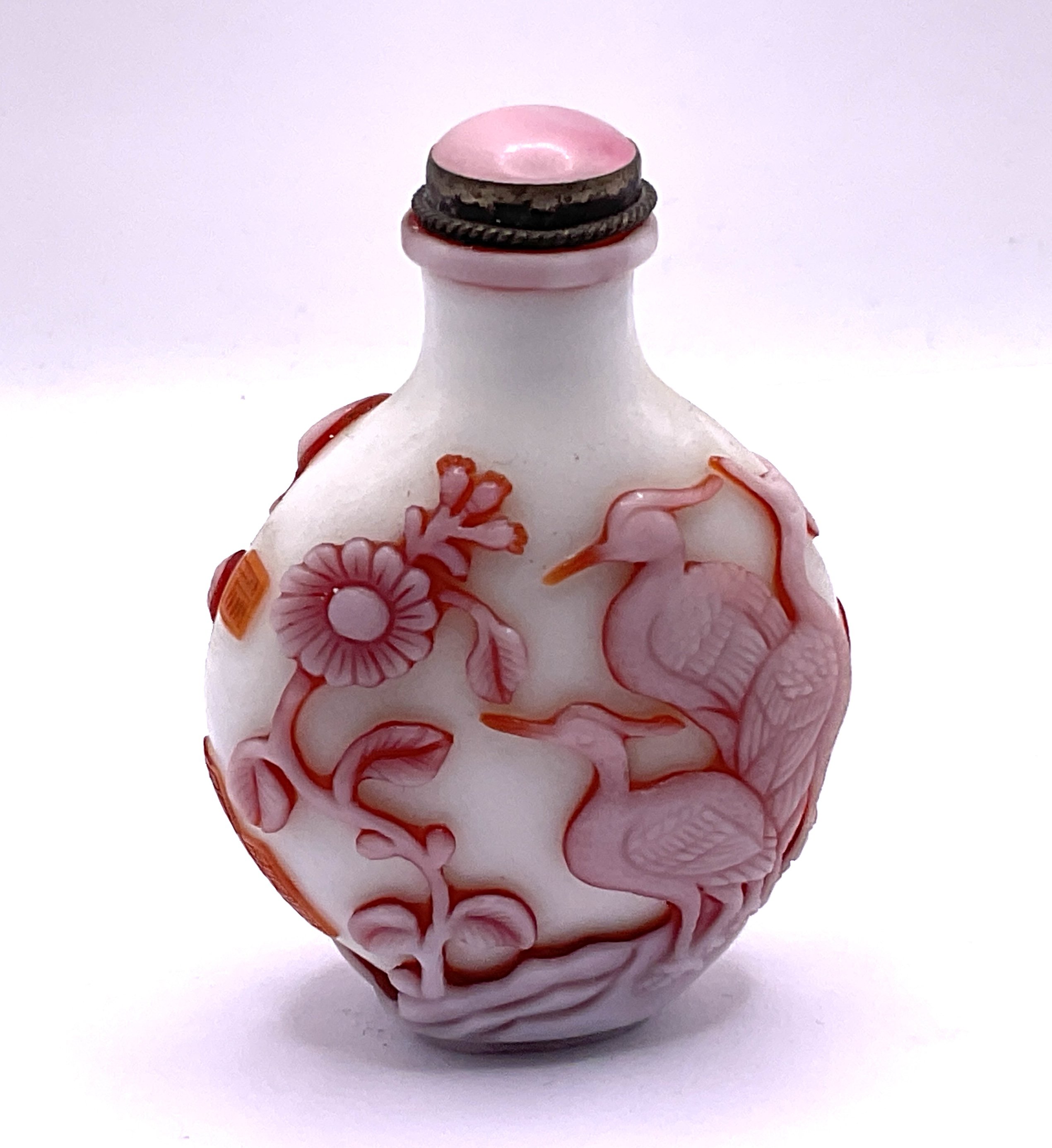 A 2 layered milk glass cameo glass snuff bottle with decoration of Cranes and flowers, signature panel to side. 6.8cm.