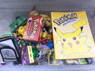 A Box Containing Vintage Pokemon Cards And Toys.