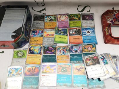 A Large Collection Of Pokemon Cards In Large Collectors Tin Containing Over 60 Holographic Cards And Reverse Holos. Over 600 Cards..